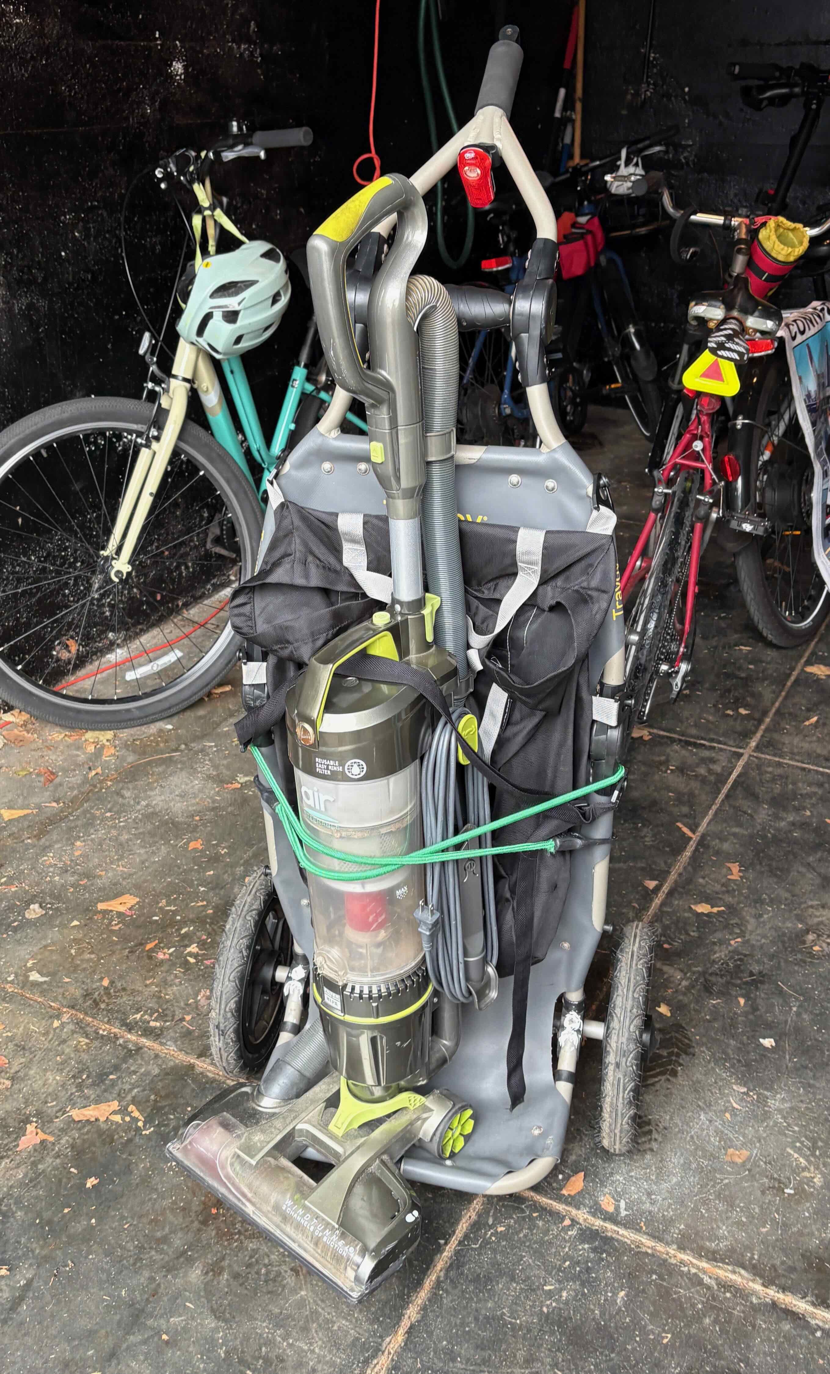 Vacuum cleaner bungeed upright to the Travoy in a garage
