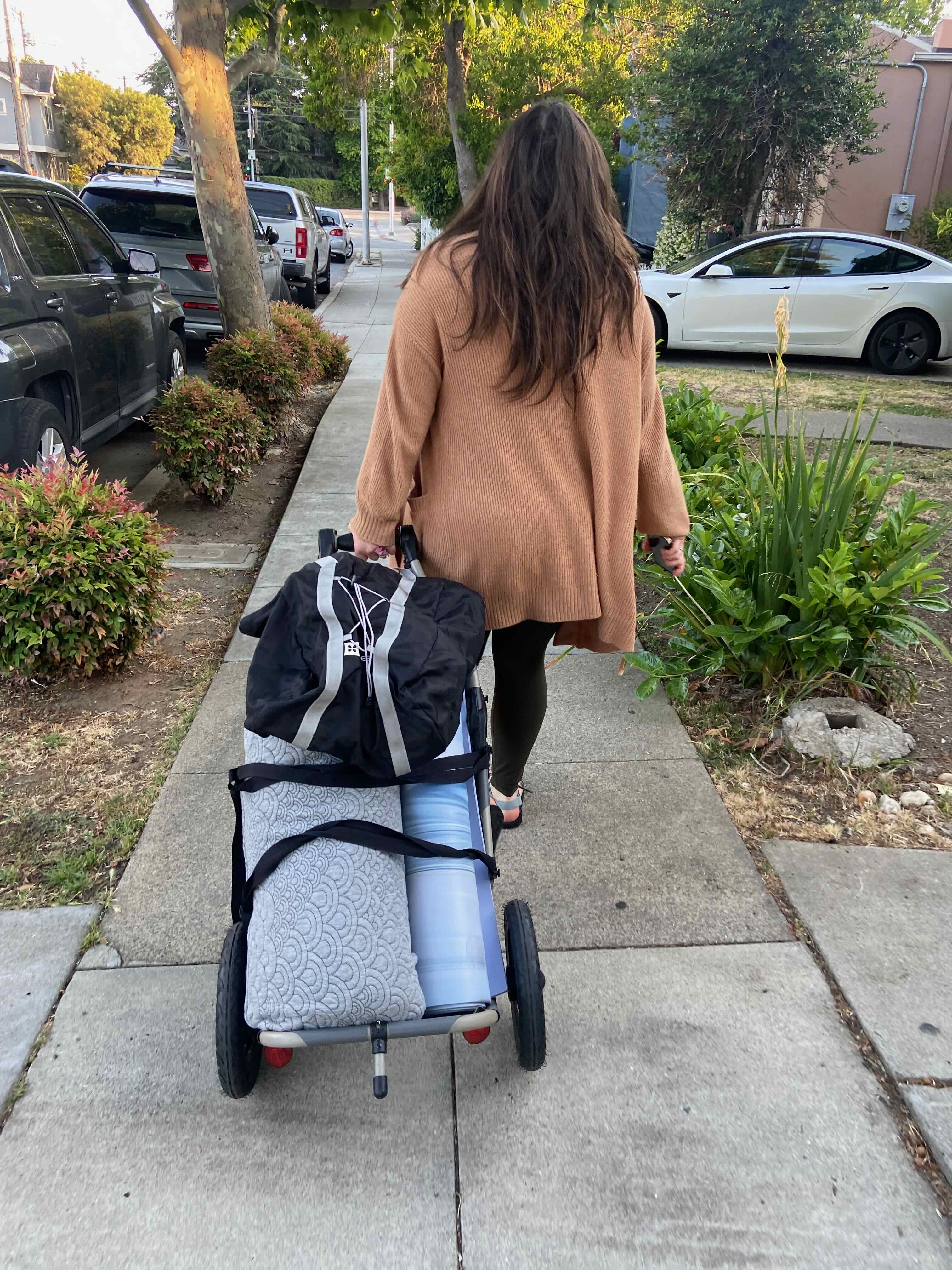 Wife rolling the Travoy as a hand cart on a sidewalk