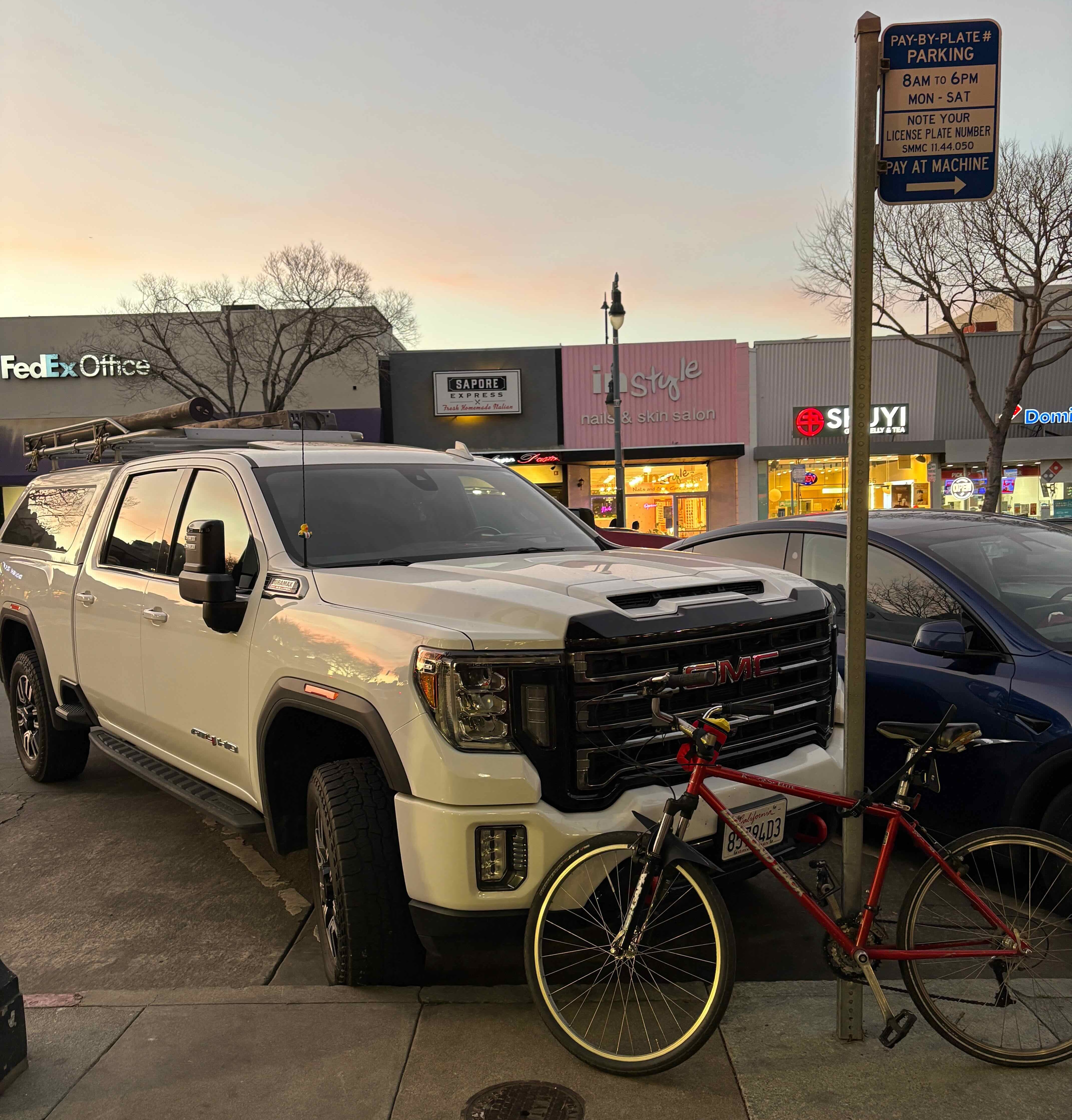 my bike locked to a signpost outside a San Mateo restaurant