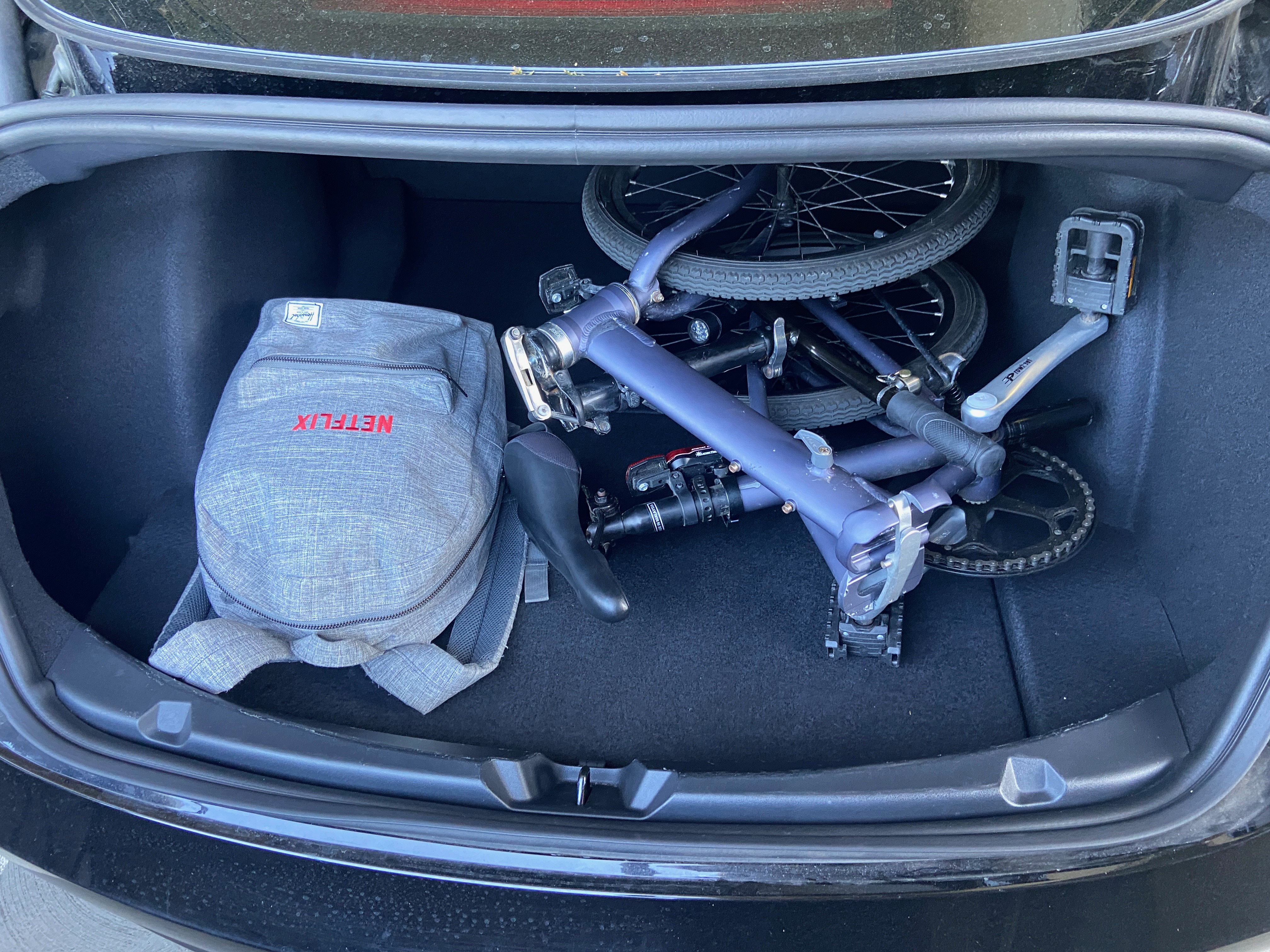 Folding bike & backpack in the trunk of a Tesla Model 3