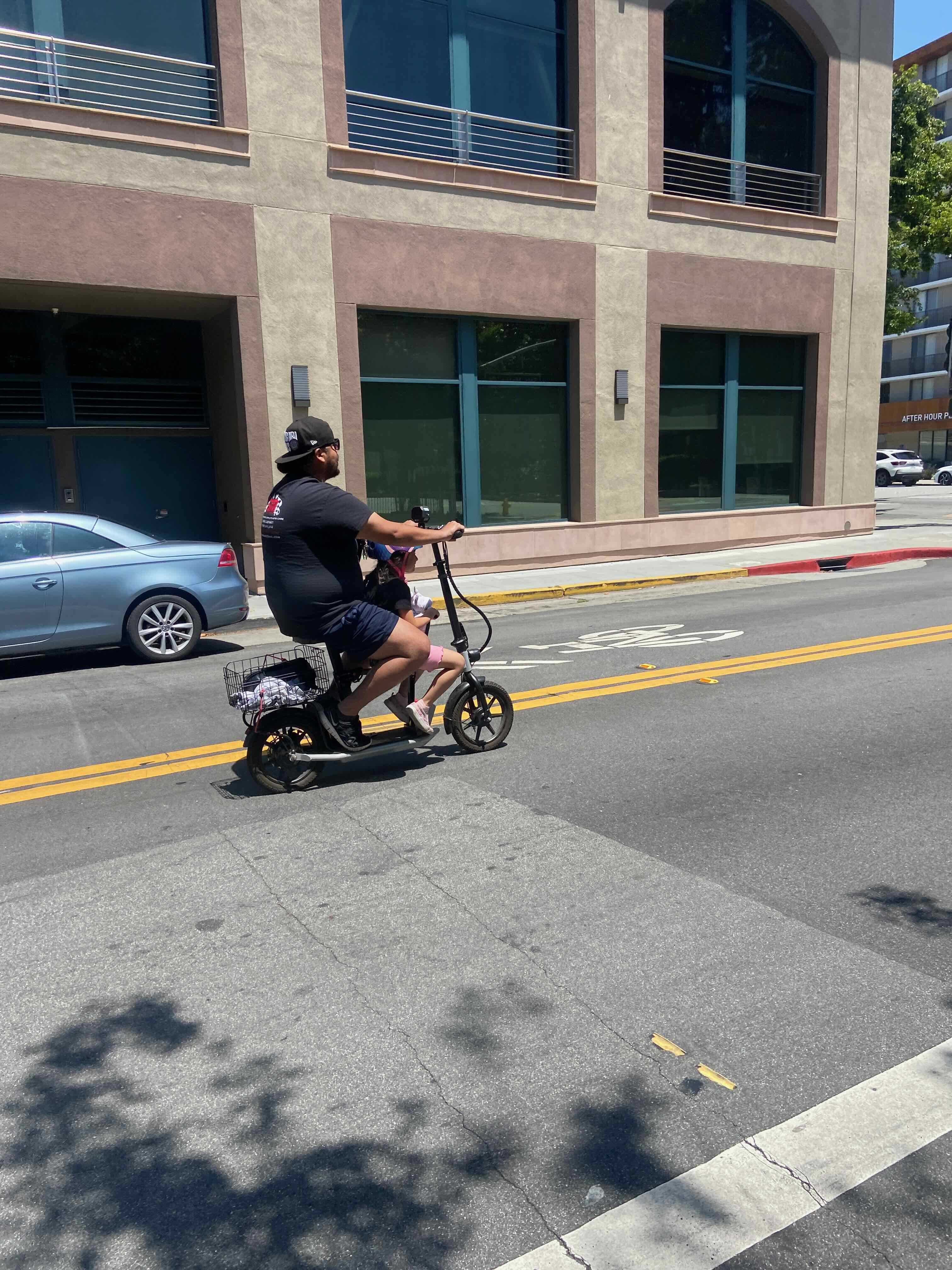 Father-daughter electric scooter ride