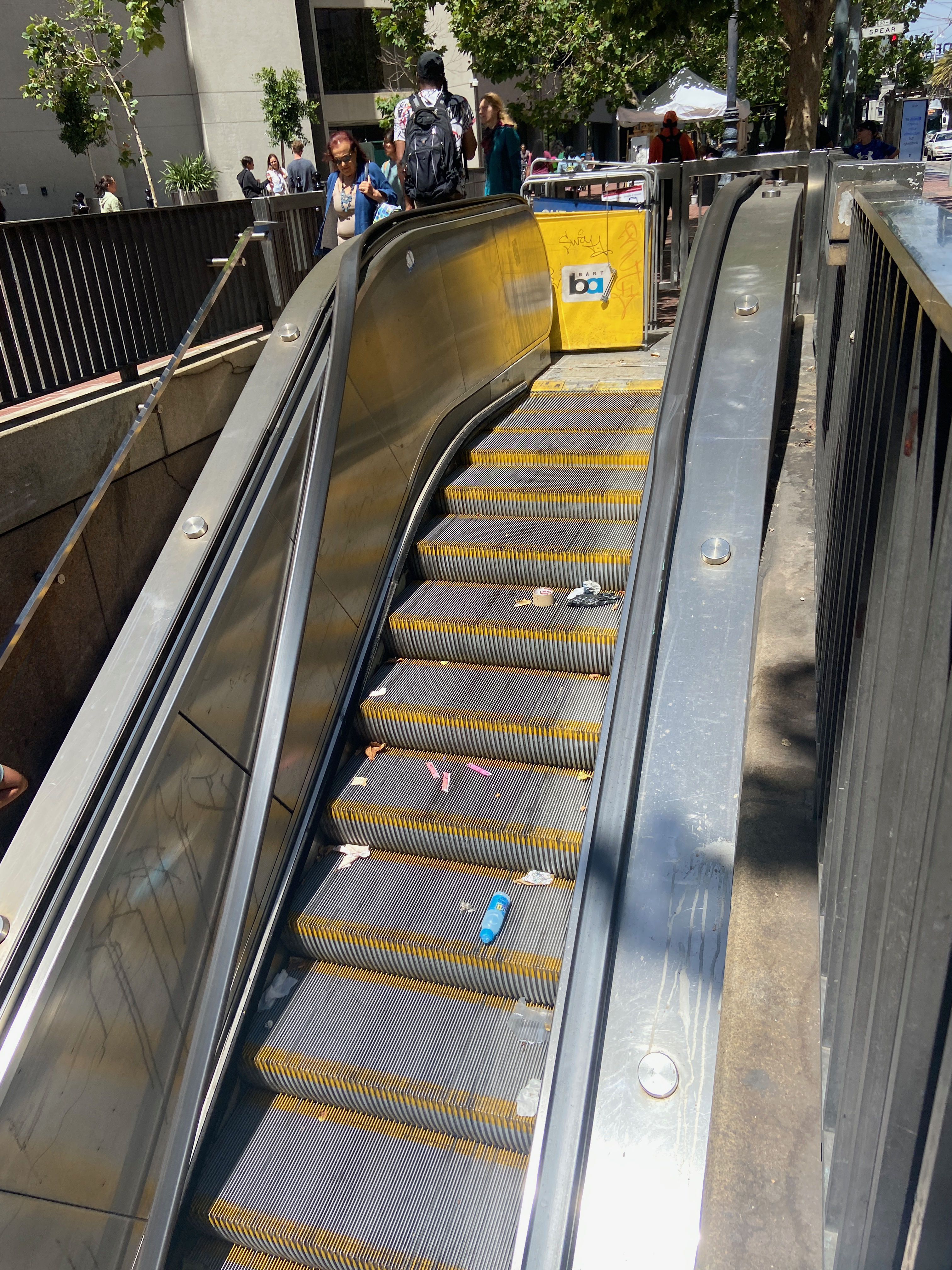 An out of service BART escalator, collecting trash