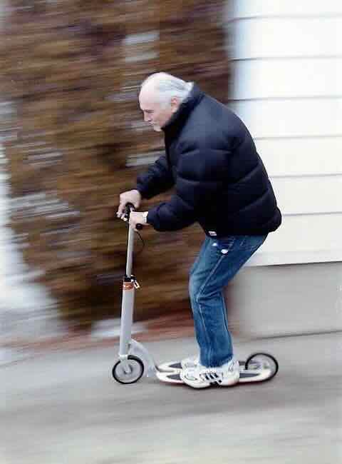 a baller old man riding a Xootr kickscooter