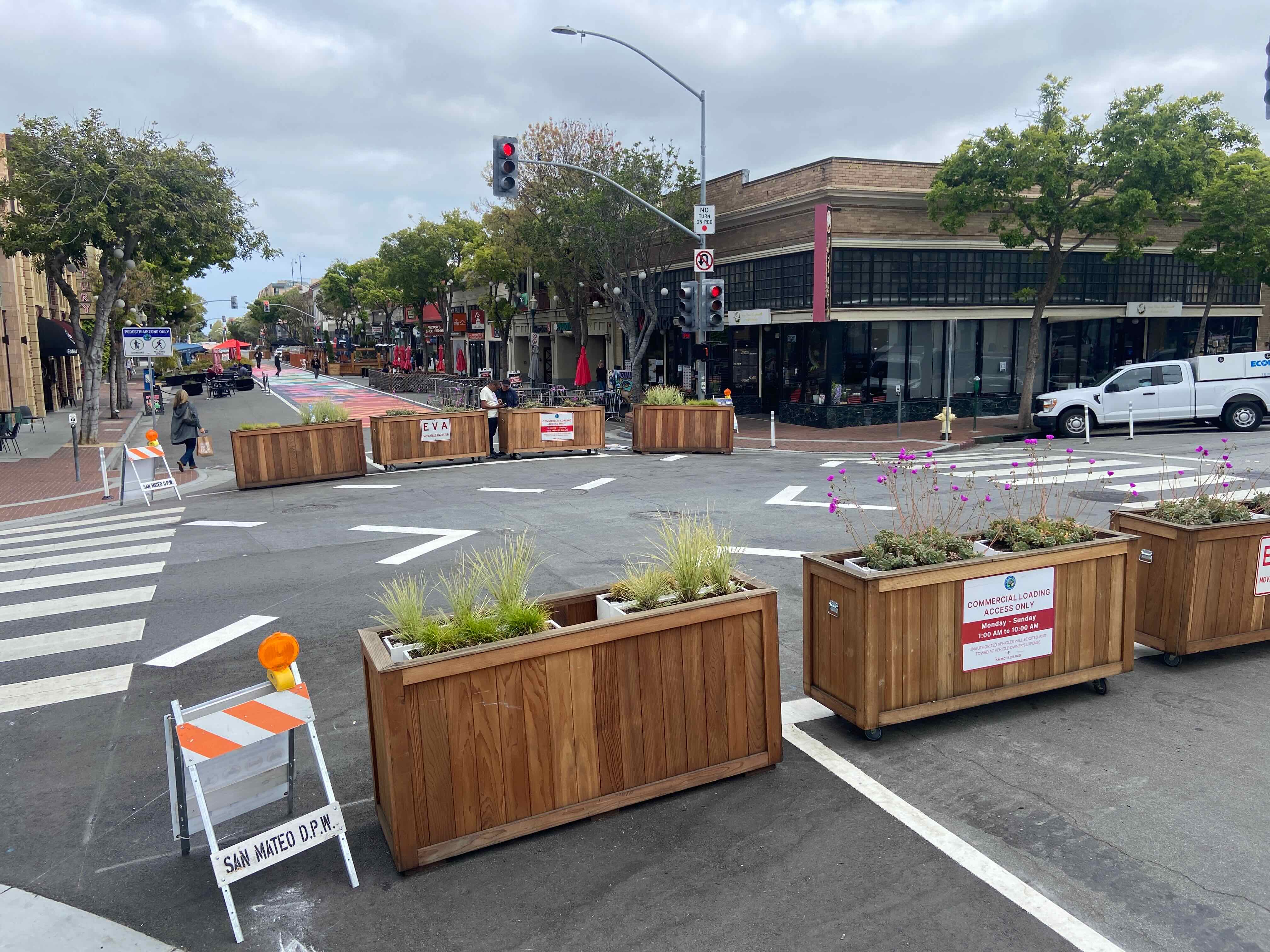 Wooden planters on wheels blocking B Street in downtown San Mateo