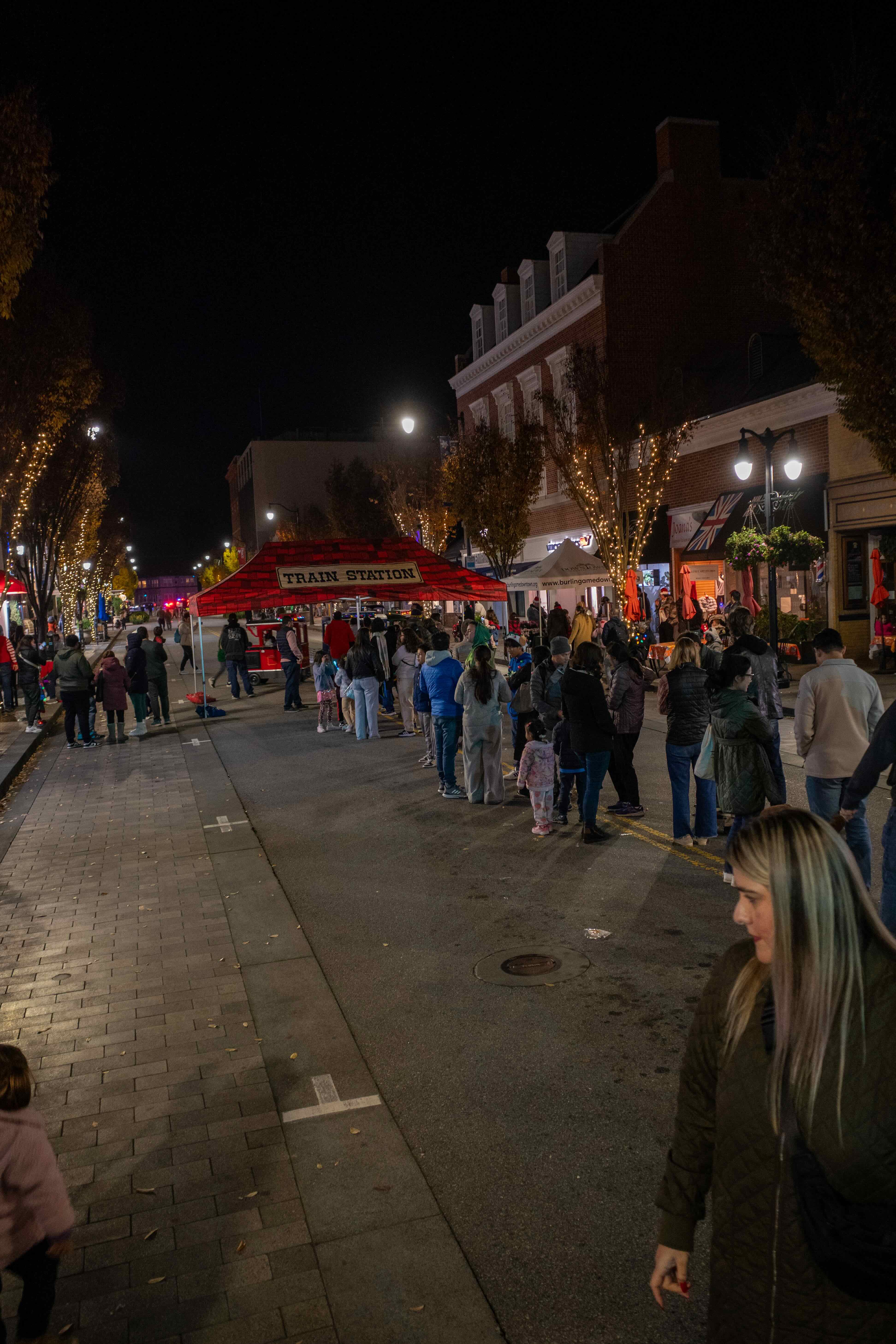 A long line of families waiting to ride the holiday choo choo train on Burlingame Avenue