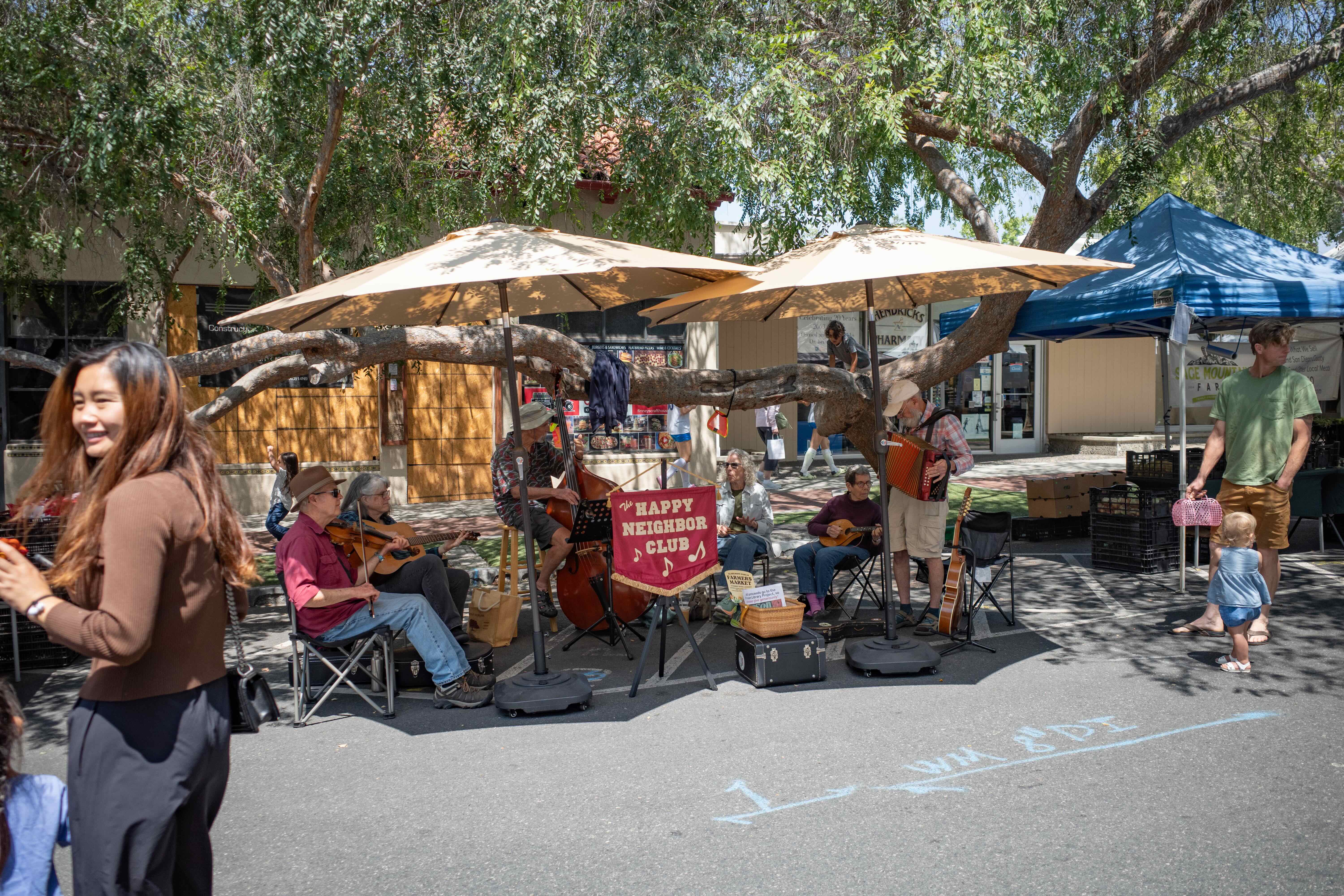 The Happy Neighbor Club band performing at the Claremont farmers market