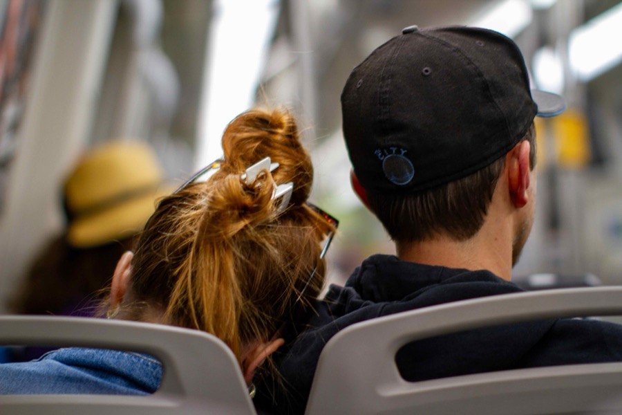 a couple sitting next to each other in BART seats