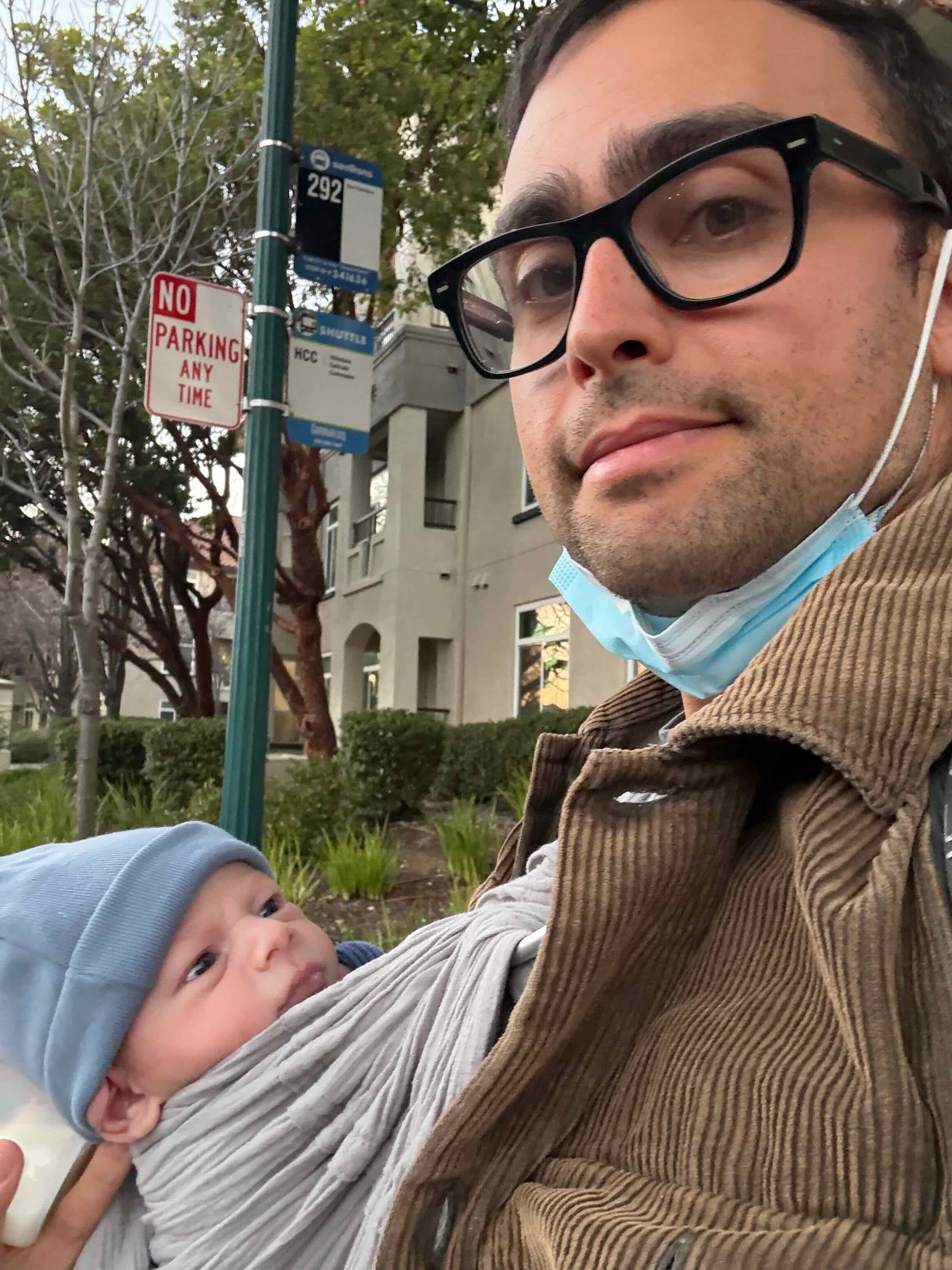 Waiting for the Route 292 bus with my son in a carrier