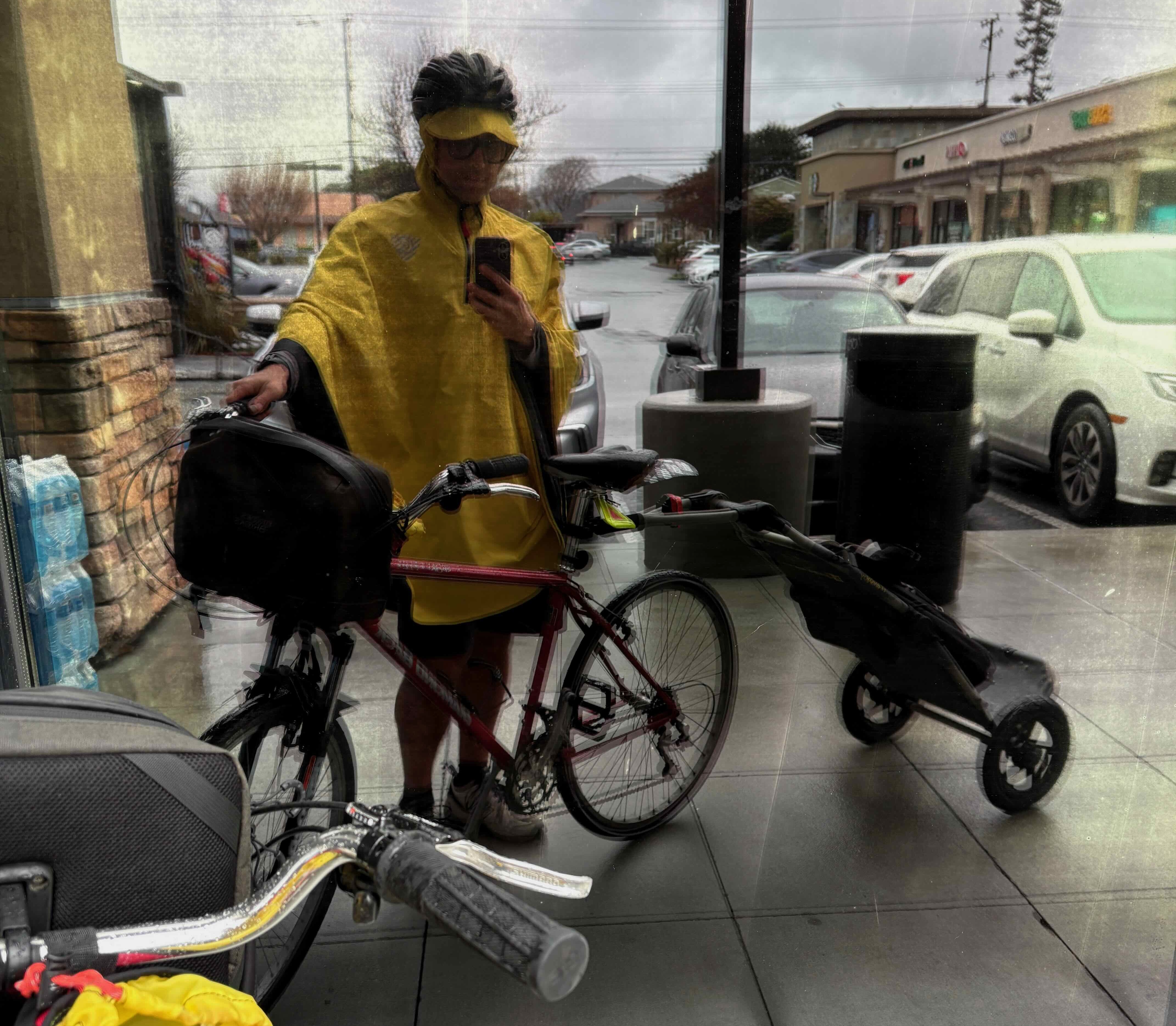 Rain gear at a San Mateo grocery store — helmet, poncho, trailer