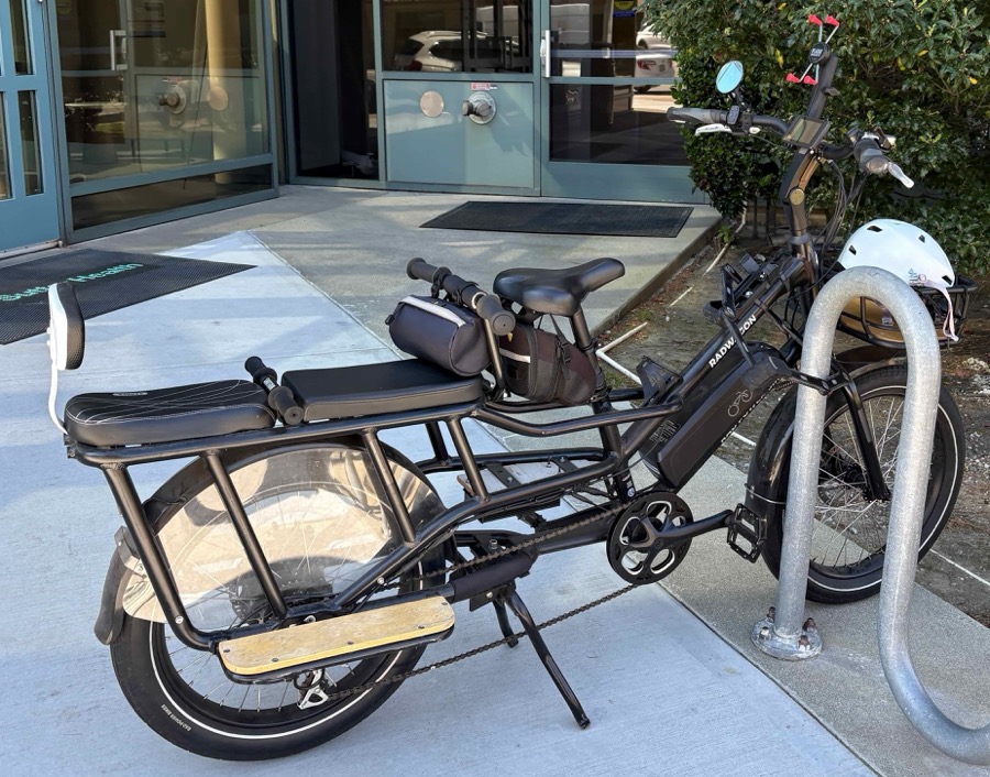 A longtail cargo bike loaded with children and bags