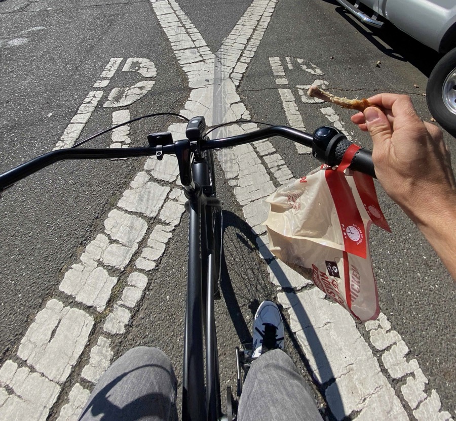 a shopping bag hanging from bicycle handlebars